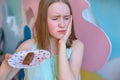 Teen woman pressing her bruised cheek with a painful expression as if she& x27;s having a terrible tooth ache. Holding Royalty Free Stock Photo