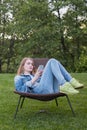 Teen woman using smartphone outside garden Royalty Free Stock Photo