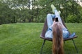 Teen woman using smartphone outside garden Royalty Free Stock Photo