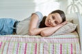 Teenage girl sleeping at home in bed, calm teenager looking at camera Royalty Free Stock Photo