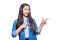 Teenage girl pointing fingers to the side at space for text, on white isolated background Royalty Free Stock Photo