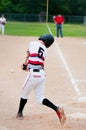 Youth baseball batter hitting ball.