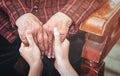 Teenage asia young girl carer holding grandma hands, concept of helping care for the elderly life with dark background, close up, Royalty Free Stock Photo