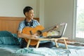Teenage of asian boy learning guitar