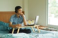 Teenage of asian boy with serious face looking to laptop and wearing headset Royalty Free Stock Photo