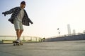 teenage asian boy skateboarding outdoors