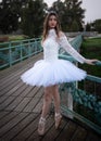 Ballerina wearing white dress and point shoes dancing ballet outdoors Royalty Free Stock Photo