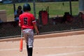 Teenage baseball player from behind.