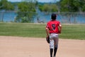 Teenage baseball shortstop on field with copy space.