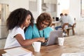 Teenage African American  girl helping her grandmother use a laptop computer at home, close up Royalty Free Stock Photo