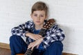 Portrait of a handsome boy plays guitar