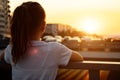 Teenage blonde with long hair in ponytail admires sunset