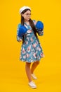 Teenage boxer girl in boxing gloves on yellow isolated background.