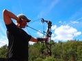 A boy practices archery at an outdoor range Royalty Free Stock Photo