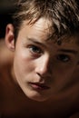 Teenage Boy with Bare Skin Looking Up at Camera Royalty Free Stock Photo