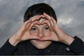 Teenage boy in black hoodie against dark cloudy sky Royalty Free Stock Photo