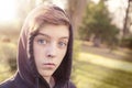 Teenage boy with black hoodie in a park Royalty Free Stock Photo