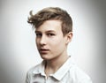 Portrait of a teenage boy blond on a white background close-up Royalty Free Stock Photo