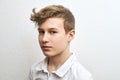 Portrait of a teenage boy blond on a white background close-up Royalty Free Stock Photo