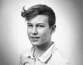 Portrait of a teenage boy blond on a white background close-up