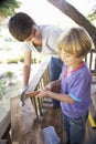 Teenage Boy And Brother Building Tree House Together Royalty Free Stock Photo