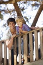 Teenage Boy And Brother Playing In Tree House Together Royalty Free Stock Photo