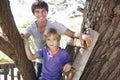 Teenage Boy And Brother Playing In Tree House Together Royalty Free Stock Photo