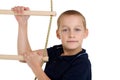 Teenage boy climbiing on rope ladder