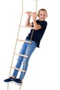 Teenage boy climbiing on rope ladder
