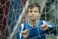 A teenage boy closeup portrait near the gate on the football field. Royalty Free Stock Photo