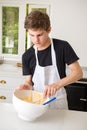 A Teenage Boy Cooking In A Kitchen