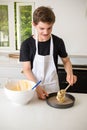 A Teenage Boy Cooking In A Kitchen