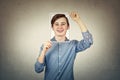 Teenage boy covering face using a paper photo print with self portrait sketch, like a mask for hiding the true emotion. Private Royalty Free Stock Photo