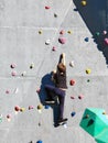 A teenage boy is crawling on a rock climbing wall in training Royalty Free Stock Photo