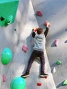 A teenage boy is crawling on a rock climbing wall in training Royalty Free Stock Photo