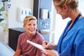 Teenage Boy And Doctor Have Consultation In Hospital Room Royalty Free Stock Photo