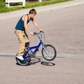 Teenage boy doing tricks on a BMX bike.