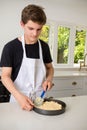 A Teenage Boy Cooking In A Kitchen