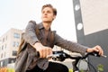 Teenage boy with earphones and bag riding bicycle Royalty Free Stock Photo