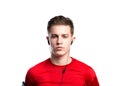 Teenage boy with earphones, in red sports sweatshirt. Isolated.