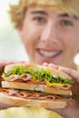 Teenage Boy Eating Sandwich Royalty Free Stock Photo