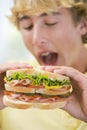 Teenage Boy Eating Sandwich Royalty Free Stock Photo