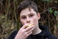 Teenage boy eats cheese sandwich Royalty Free Stock Photo