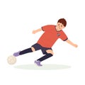 Teenage boy football player, in a red sports shirt, kicks a soccer ball. Kid sportsman playing football game, dynamic Royalty Free Stock Photo