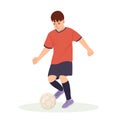 Teenage boy football player, in a red sports shirt, kicks a soccer ball. Kid sportsman playing football game, dynamic Royalty Free Stock Photo