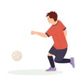 Teenage boy football player, in a red sports shirt, kicks a soccer ball. Kid sportsman playing football game, dynamic Royalty Free Stock Photo