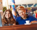 Teenage boy and girl in cafe