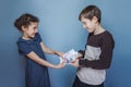 Teenage boy and girl holding money bills in his