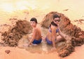 Teenage boy and girl play with sand on the beach Royalty Free Stock Photo