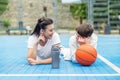 Teenage boy and girl are sitting on sports field, drinking water and talking during break Royalty Free Stock Photo